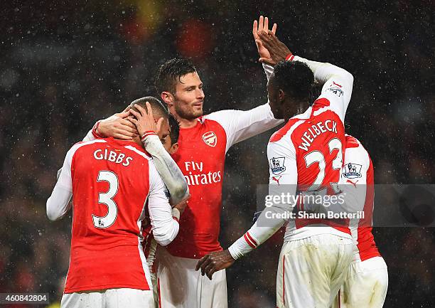 Olivier Giroud of Arsenal celebrates the goal scored by Alexis Sanchez with Danny Welbeck during the Barclays Premier League match between Arsenal...