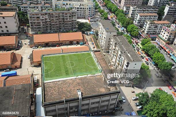 Photo shows a football field, 40 meters in length and 20 meters in width, built on the roof of a four-story warehouse on May 9, 2013 in Nanning,...