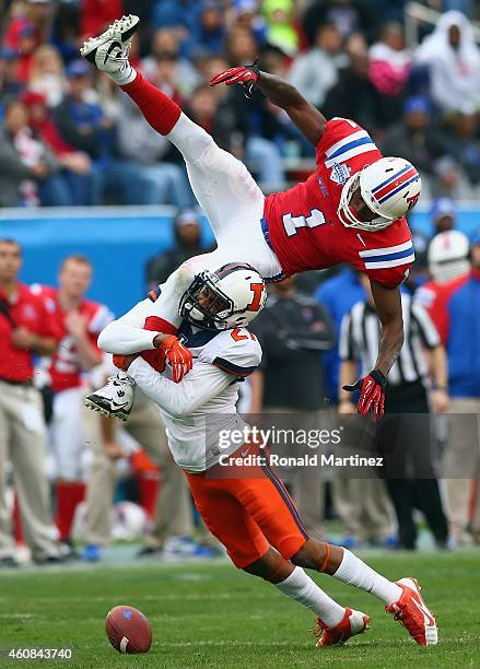 Carlos Henderson of the Louisiana Tech Bulldogs is tackled by Eaton Spence of the Illinois Fighting Illini on a pass play during the Zaxby's Heart of...