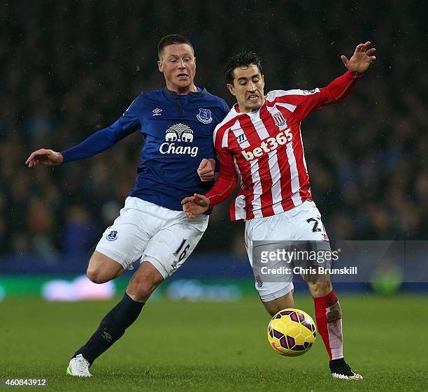 James McCarthy of Everton in action with Bojan Krkic of Stoke City during the Barclays Premier League match between Everton and Stoke City at...