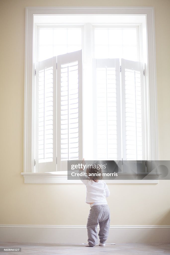 Boy peeking out window