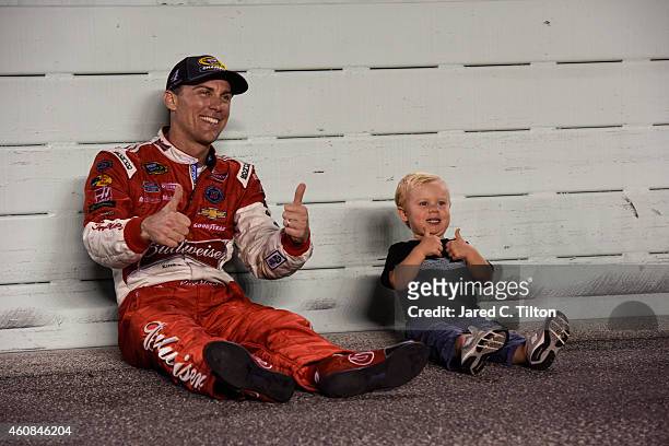 Kevin Harvick, driver of the Budweiser Chevrolet, poses for a portrait with son Keelan after winning the NASCAR Sprint Cup Series championship...