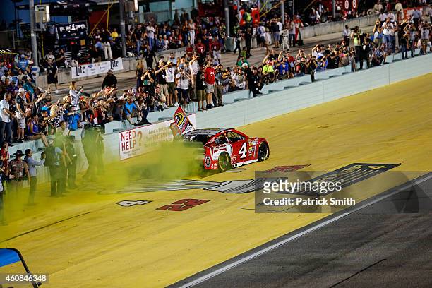 Kevin Harvick, driver of the Budweiser Chevrolet, celebrates after winning during the NASCAR Sprint Cup Series Ford EcoBoost 400 at Homestead-Miami...