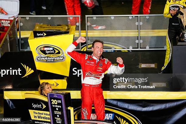 Kevin Harvick, driver of the Budweiser Chevrolet, celebrates in victory lane after winning during the NASCAR Sprint Cup Series Ford EcoBoost 400 at...