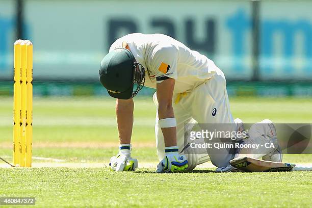 Steve Smith of Australia drops to his knees after being hit in the groin during day two of the Third Test match between Australia and India at...