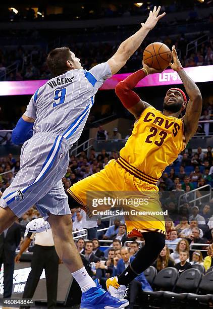 Cleveland Cavaliers forward LeBron James attempts a shot against Orlando Magic center Nikola Vucevic during the game at Amway Center on December 26,...