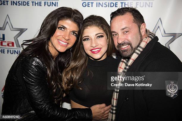 Teresa Giudice, Gia Giudice and Joe Giudice pose at iPlay America on December 26, 2014 in Freehold, New Jersey.