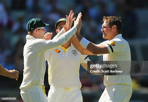 Ryan Harris of Australia celebrates with Steven Smith after dismissing Shikhar Dhawan of India during day two of the Third Test match between...