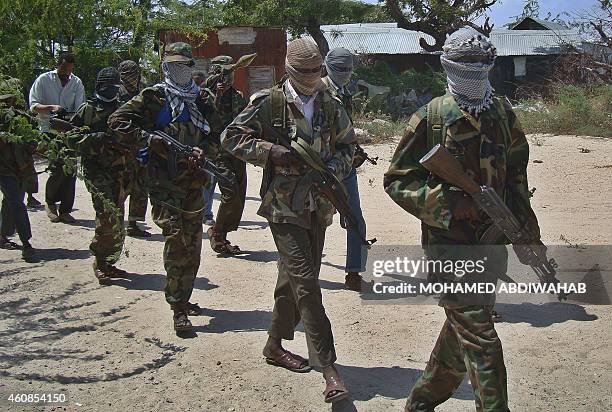 Al-Qaeda linked al-shabab recruits walk down a street on March 5, 2012 in the Deniile district of the Somalian capital, Mogadishu, following their...
