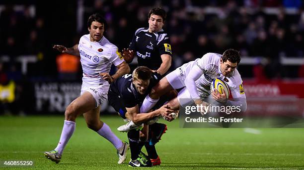 Falcons replacement Chris Harris tackles Saracens full back Alex Goode during the Aviva Premiership match between Newcastle Falcons and Saracens at...