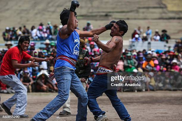 Two men fight during Takanakuy celebrations in the region of Chumbivilcas, Cuzco in the Andes of southern Peru on December 25, 2014. The Takanakuy is...