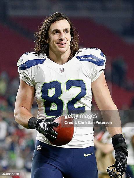 Tight end Luke Willson of the Seattle Seahawks runs off the field with the "sunday night football player of the game ball" after defeating the...