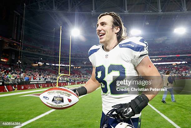 Tight end Luke Willson of the Seattle Seahawks runs off the field with the "sunday night football player of the game ball" after defeating the...