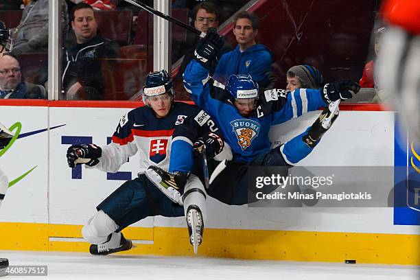 David Soltes of Team Slovakia checks Artturi Lehkonen of Team Finland during the 2015 IIHF World Junior Hockey Championship game at the Bell Centre...