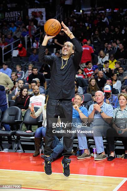 French Montana shoots a basketball at a basketball game between the Toronto Raptors and the Los Angeles Clippers at Staples Center on December 27,...