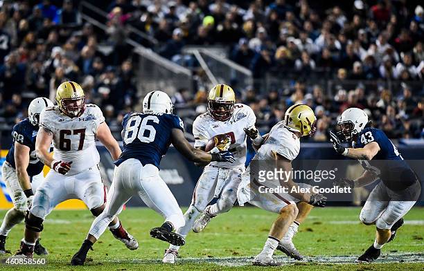 Tyler Murphy of the Boston College Eagles runs around C.J. Olaniyan of the Penn State Nittany Lions in the second quarter of the 2014 New Era...