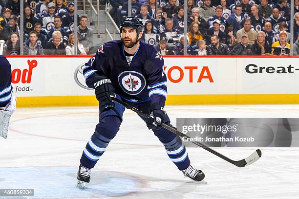 Jay Harrison of the Winnipeg Jets keeps an eye on the play during first period action against the Boston Bruins on December 19, 2014 at the MTS...