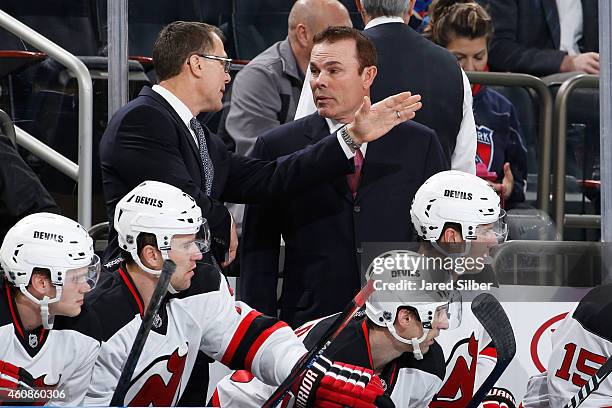 Co-coaches Adam Oates and Scott Stevens of the New Jersey Devils talk on the bench during the game against the New York Rangers at Madison Square...