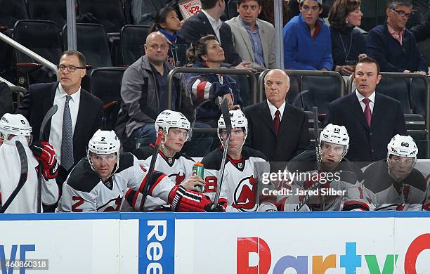 Interim coach Lou Lamoriello and Co-coaches Adam Oates and Scott Stevens of the New Jersey Devils follow the action from the bench during the game...