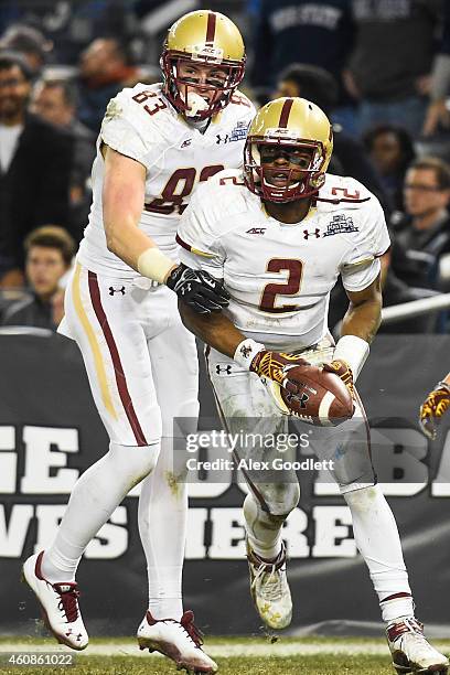 Tyler Murphy of the Boston College Eagles celebrates a touchdown with teammate Charlie Callinan in the second half during a game against the Penn...