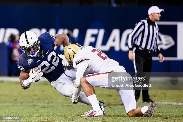 Manuel Asprilla of the Boston College Eagles hits Akeel Lynch of the Penn State Nittany Lions in the fourth quarter of the 2014 New Era Pinstripe...