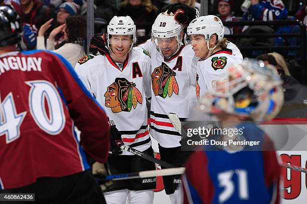 Patrick Sharp of the Chicago Blackhawks celebrates his goal against goalie Calvin Pickard of the Colorado Avalanche with teammates Duncan Keith and...