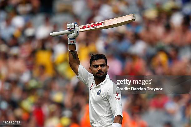 Virat Kohli of India raises his bat after scoring 100 runs during day three of the Third Test match between Australia and India at Melbourne Cricket...