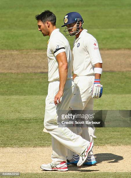 Virat Kohli of India exchanges words with bowler Mitchell Johnson of Australia after hitting him for a boundary during day three of the Third Test...