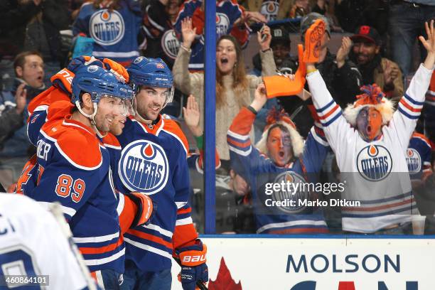 Sam Gagner, Taylor Hall and Justin Schultz of the Edmonton Oilers celebrate after a goal in a game against the Tampa Bay Lightning on January 5, 2014...