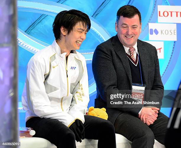 Yuzuru Hanyu smiles with his coach Brian Orser at a kiss and cry after competing in the Men's Singles Free Program during day two of the 83rd All...