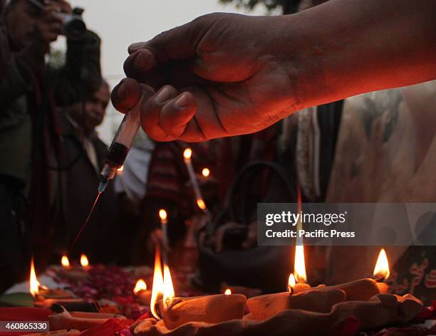 Activists of the Pakistan Peoples Party Human Right wing putting their blood in the clay lamps on the eve of 7th death anniversary of former Prime...
