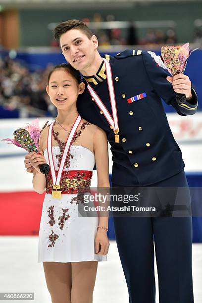 Ami Koga and Francis Boudreau Audet of Japan pose with gold medal in the award ceremony for pairs Junior during the 83rd All Japan Figure Skating...