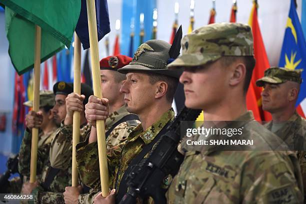 Led International Security Assistance Force soldiers carry flags during a ceremony marking the end of ISAF's combat mission in Afghanistan at ISAF...