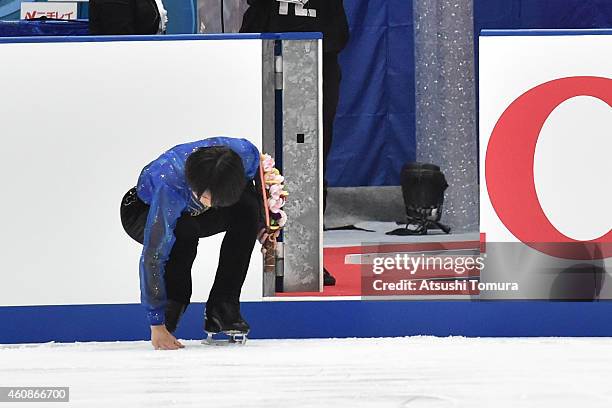 Tatsuki Machida of Japan touches ice as he exits the ice rink after announce his retirement at the end of the 83rd All Japan Figure Skating...