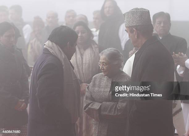 Congress leaders Ghulam Nabi Azad with Sheila Dikshit during Congress Partys 130th foundation day at AICC Headquarters during heavy fog on December...