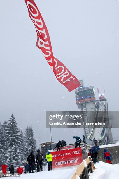 Technicans prepare the jumping hill during a break in the heavy snow and windy conditions on day 2 of the Four Hills Tournament Ski Jumping event at...