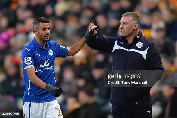 Nigel Pearson, manager of Leicester City congratulates Riyad Mahrez of Leicester City on the scoring the opening goal during the Barclays Premier...