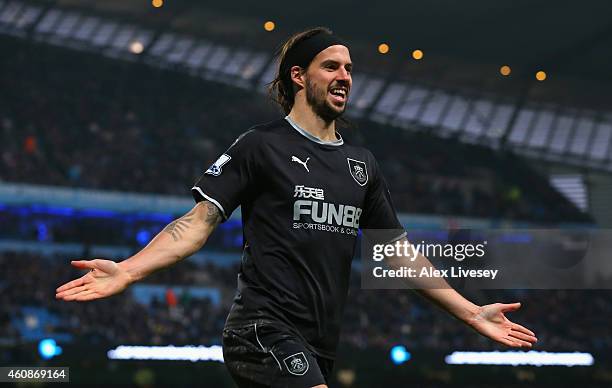 George Boyd of Burnley celebrates scoring their first goal during the Barclays Premier League match between Manchester City and Burnley at Etihad...