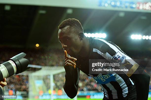 Papiss Demba Cisse of Newcastle United celebrates after scoring a goal to level the scores at 1-1 during the Barclays Premier League match between...