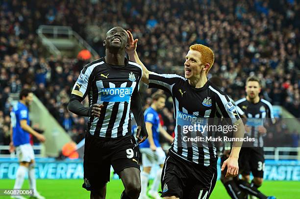 Papiss Demba Cisse of Newcastle United celebrates with teammate Jack Colback after scoring a goal to level the scores at 1-1 during the Barclays...