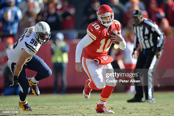 Chase Daniel of the Kansas City Chiefs runs the ball as Jarret Johnson of the San Diego Chargers defends in the first half at Arrowhead Stadium on...