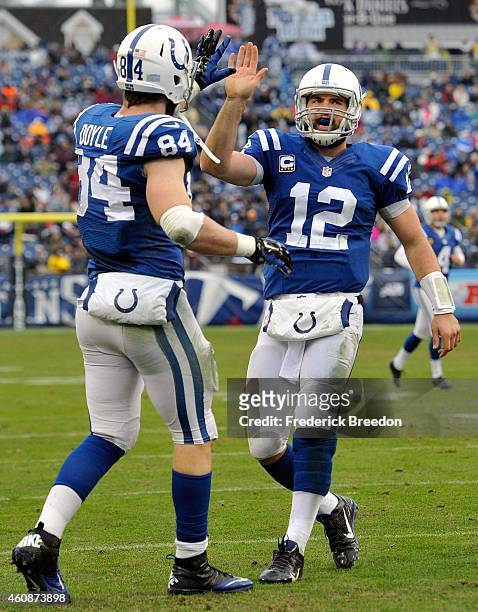 Quarterback Andrew Luck of the Indianapolis Colts congratulates teammate Jack Doyle on scoring a touchdown against the Tennessee Titans during the...