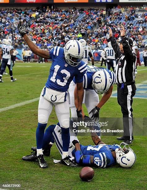 Hilton of the Indianapolis Colts calls for a trainer for teammate Reggie Wayne who was injured making an eighty yard pass reception against the...