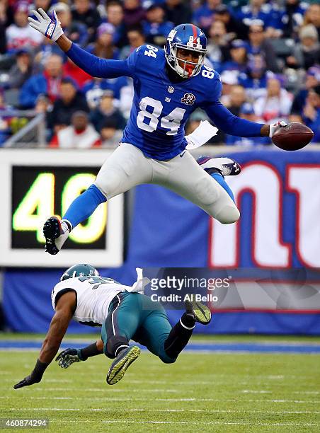 Larry Donnell of the New York Giants jumps over Jaylen Watkins of the Philadelphia Eagles in the third quarter during a game at MetLife Stadium on...