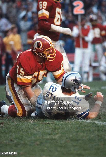 Dave Butz of the Washington Redskins hits Roger Staubach of the Dallas Cowboys during an NFL football game November 18, 1979 at RFK Stadium in...