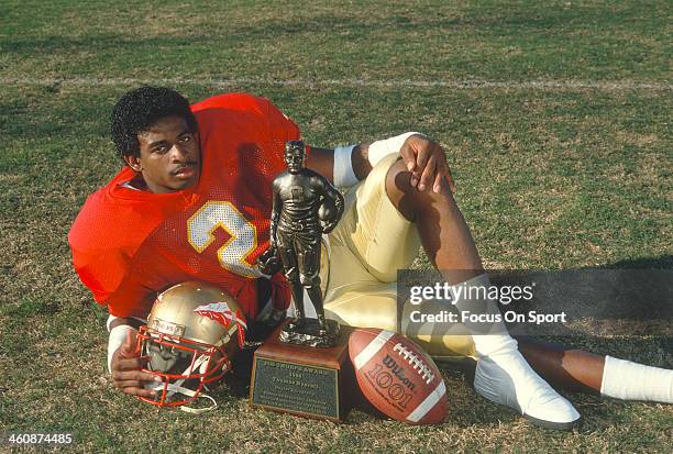 Defensive back Deion Sanders of the Florida State Seminoles winner of the 1988 Jim Thorpe Award, poses with the trophy circa 1988 at Doak Campbell...