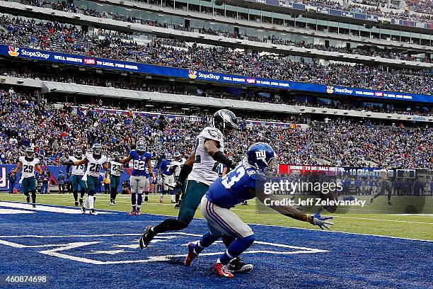 Odell Beckham of the New York Giants tries to make a catch as Brandon Boykin of the Philadelphia Eagles defends during a game at MetLife Stadium on...