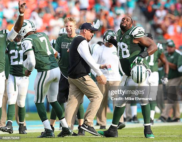 Head coach Rex Ryan of the New York Jets celebrates a fourth quarter touchdown by tight end Jeff Cumberland with defensive tackle Leger Douzable,...