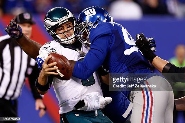 Jason Pierre-Paul of the New York Giants sacks Mark Sanchez of the Philadelphia Eagles during a game at MetLife Stadium on December 28, 2014 in East...