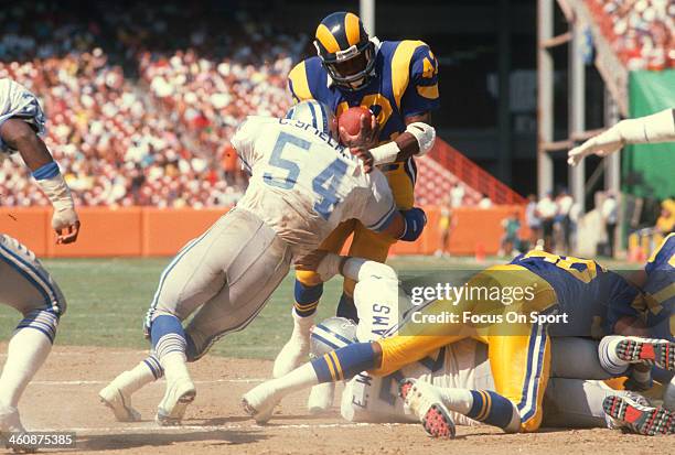 Greg Bell of the Los Angeles Rams gets tackled by Chris Spielman of the Detroit Lions during an NFL football game September 11, 1988 at Anaheim...
